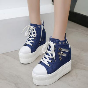 Blue skull zipper platform sneakers shown in a closer front outfit view with contrasting white laces and soles.