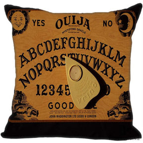 Brown square Ouija pillow cover with a classic sun-and-moon board layout, alphabet arcs, numbers and a large tan printed planchette.