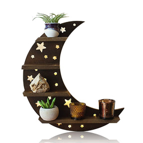 Brown crescent moon shelf with star cutouts and four ledges, styled with small plant pots, a crystal and decorative containers against white.