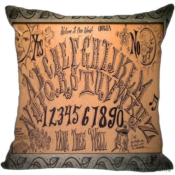 Brown square spirit-board pillow cover with ornate hand-drawn alphabet rows, numbers, faces and a patterned dark border.