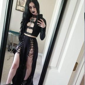 Black long sleeve buckle crop top worn with a long lace-up slit skirt in a mirror outfit view.