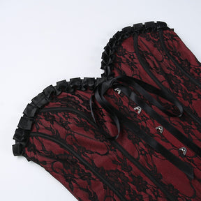 Burgundy strapless corset top with black floral lace with the bodice laid flat.