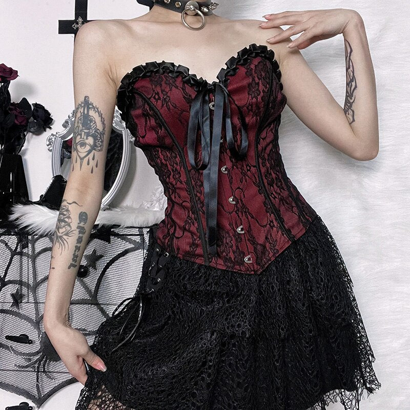 Burgundy strapless corset top with black floral lace with a view of the fitted waist and pointed hem.