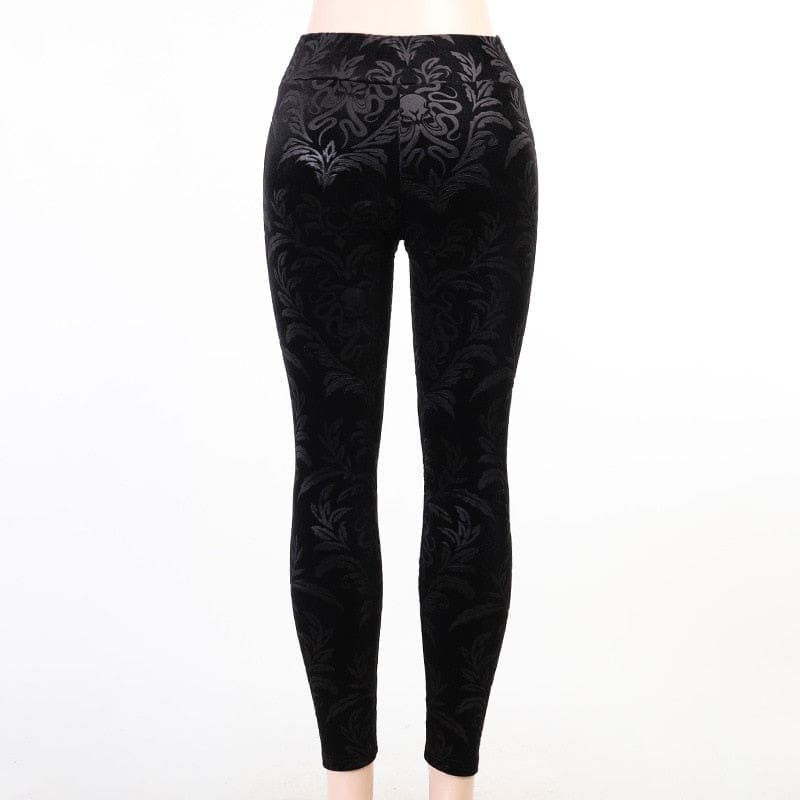Rear display of the black velvet skinny pants on white, with the scrolling pattern continuing across the back.