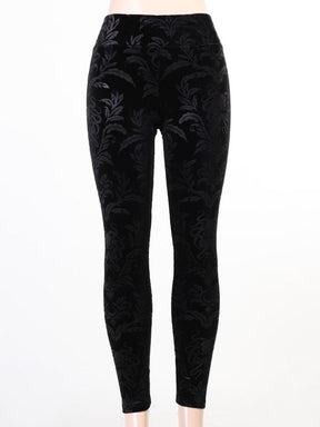 Front display of black velvet skinny pants on white, with a broad high waistband and an all-over dark botanical pattern.
