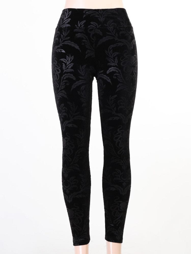 Front display of black velvet skinny pants on white, with a broad high waistband and an all-over dark botanical pattern.