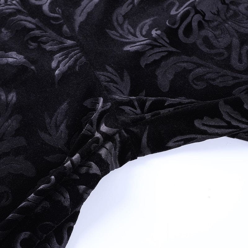 Detailed view of the pants’ central seams and tonal scrolling velvet pattern.