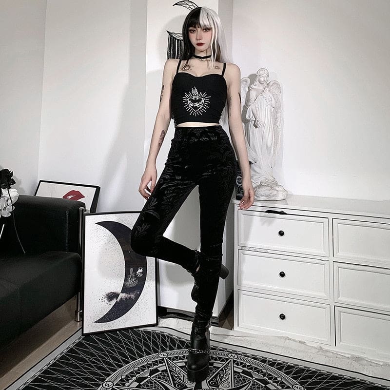 Cameo velvet pants shown standing with one knee bent, emphasizing their high waist and fitted ankle-length shape.