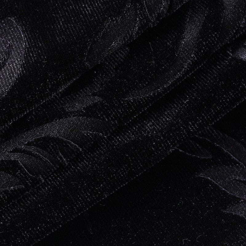 Macro view of the black velvet fabric, showing its short pile and subtle patterned surface.