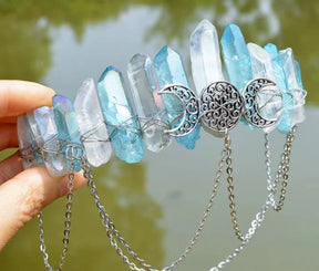 Icy pale blue and clear-looking points on a triple-moon crown with draped silver-tone chains.