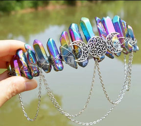 Metallic rainbow crystal crown showing purple, blue and gold reflections around a triple-moon emblem.