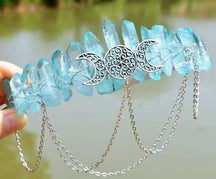 Pale blue crystal-point crown with silver-tone triple moon filigree and chain swags.