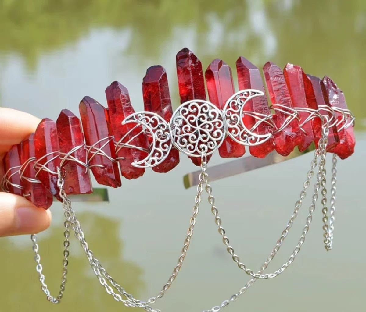 Red pointed stones wrapped with silver-tone wire on a chained triple-moon crown.