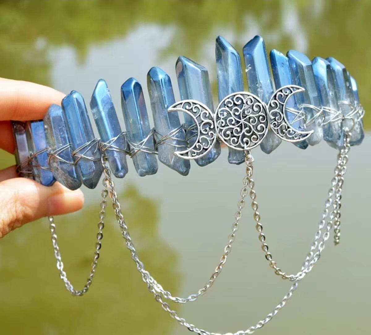 Steel-blue iridescent crystal points on a silver-tone triple-moon chain crown.