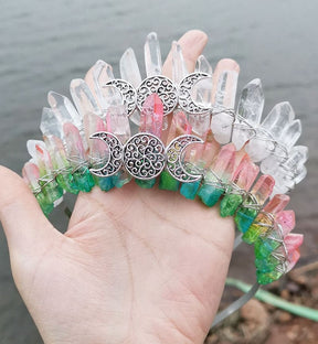 Clear and pink-green crystal crowns arranged side by side, showing the different point colours around their silver-tone triple moons.