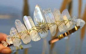Clear crystal point tiara with a gold-tone sunburst and pale translucent points around the band.