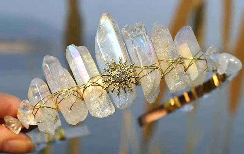 Clear crystal point tiara with a gold-tone sunburst and pale translucent points around the band.
