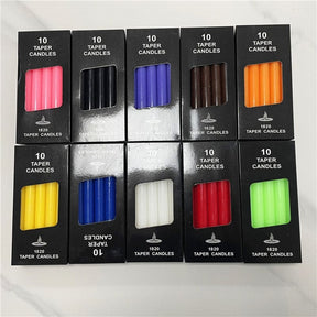 Boxes of coloured ritual candles grouped together, showing the range of packaging and candle colours.