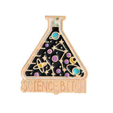 Flask-shaped enamel pin with a black background, gold-tone outlines, colourful planets and stars. The base reads Science, Bitch.