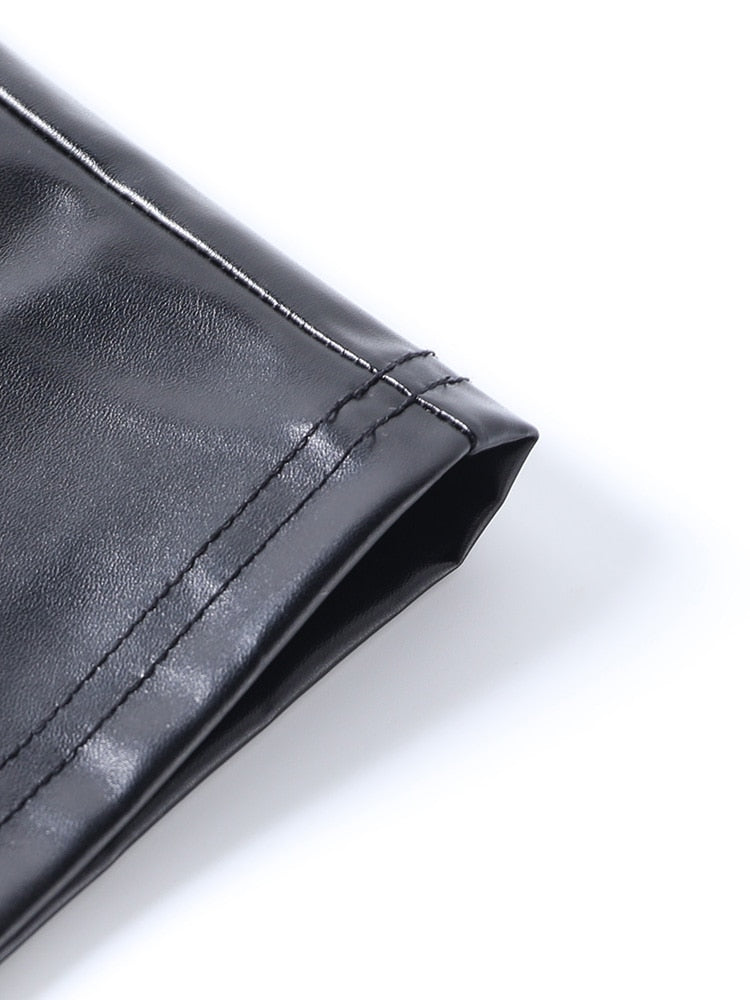 Close view of the black dress hem showing two rows of stitching along the glossy edge.