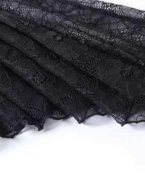 Layered black spiderweb lace with scalloped edges visible against a white background.