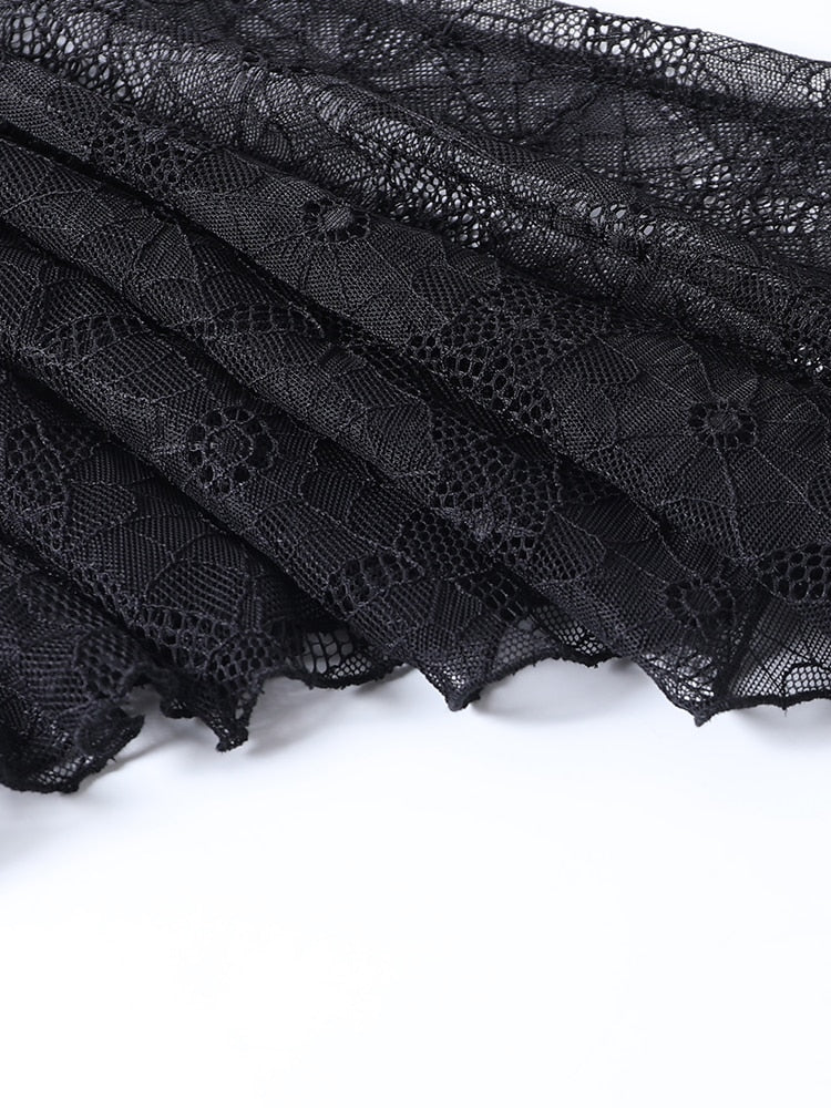Layered black spiderweb lace with scalloped edges visible against a white background.