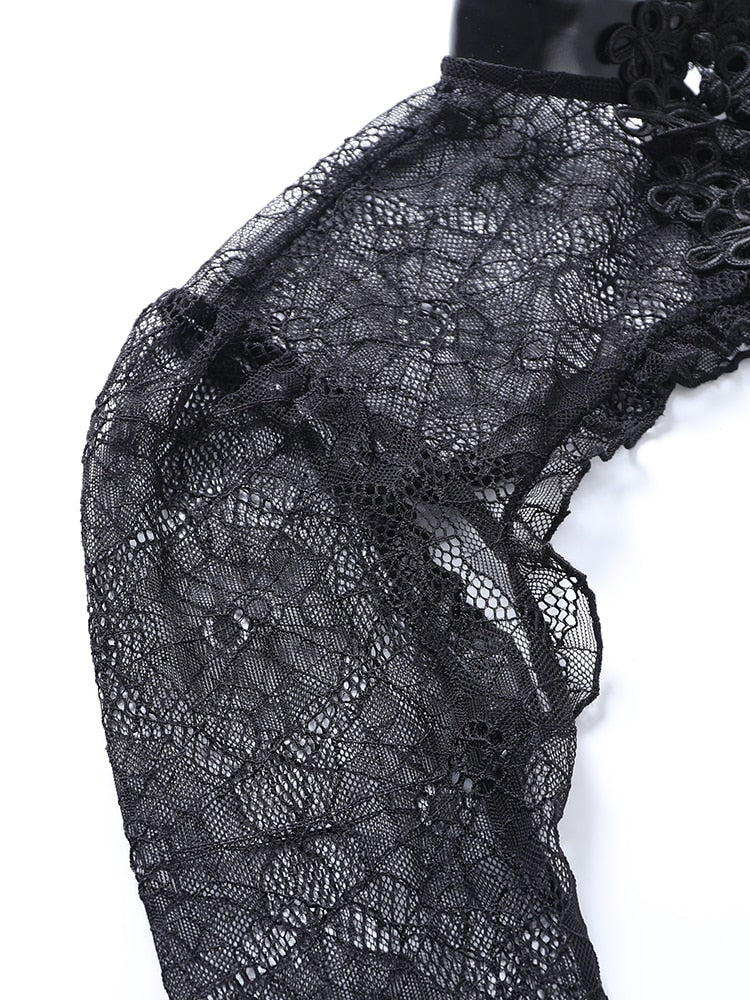 Black spiderweb lace at the overlay's shoulder, with stitched edging along the cropped body.