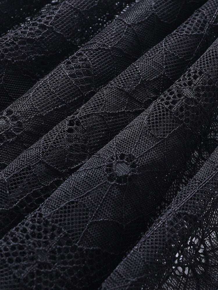 Close-up of the black spiderweb lace gathered into folds, revealing the fine mesh between the web motifs.
