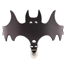 Dark brown bat-shaped garter with a matching narrow band and silver-tone clip below the face.