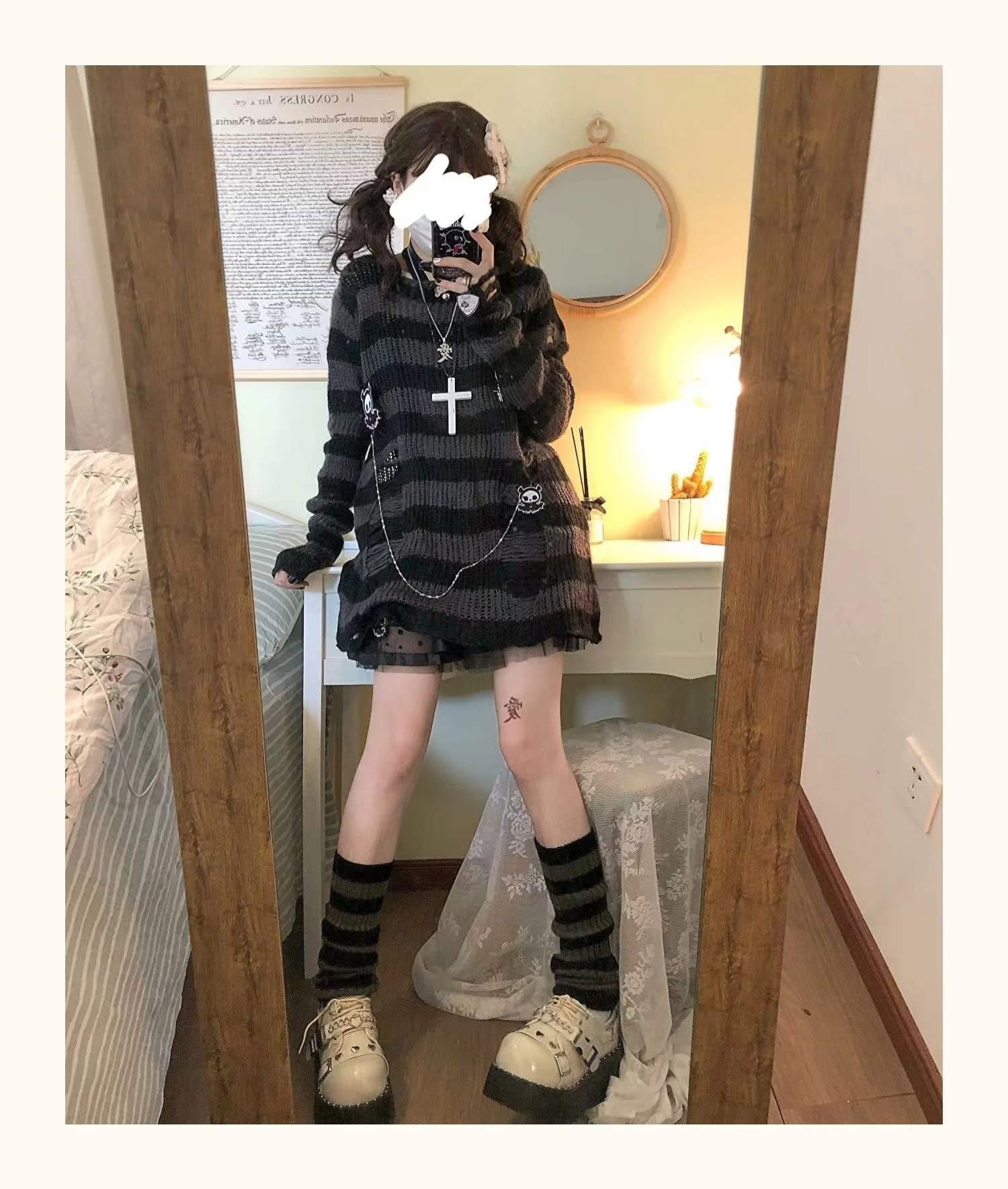 Full-length bedroom mirror outfit with a grey and black long striped sweater, short black skirt and dark striped socks. The sweater extends over the hips.