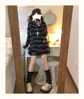 Full-length bedroom mirror outfit with a grey and black long striped sweater, short black skirt and dark striped socks. The sweater extends over the hips.