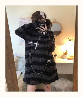 Grey and black long sweater in a full-length mirror pose with one arm lifted to the head. Long sleeves and the draped lower body are visible.