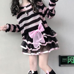 Standing staircase outfit with a pink and black cropped sweater and a layered black skirt with pink ribbon trim. A large pink bow sits at the waist.