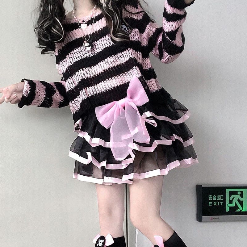 Standing staircase outfit with a pink and black cropped sweater and a layered black skirt with pink ribbon trim. A large pink bow sits at the waist.