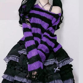 Purple and black striped cropped sweater worn off one shoulder with a dark ruffled skirt and purple bows. The long sleeve ends in a loose, distressed cuff.