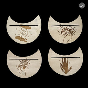 A set of four crescent card holders with eye, cards, crystal and palm motifs, shown together on a light background.