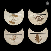 Four beige crescent card holders with eye, card, crystal and hand artwork, arranged together to show the different designs.