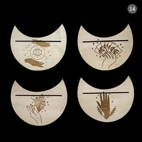 Four beige crescent card holders with eye, card, crystal and hand artwork, arranged together to show the different designs.