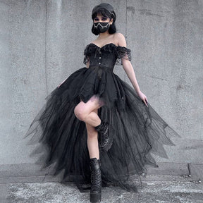 The black layered tutu skirt in a wider raised-leg pose, showing its uneven mesh panels trailing behind the shorter front.
