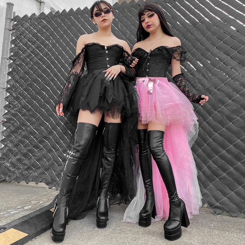 Black and pink versions of the fairy grunge skirt shown together in full outfits at a fence, each with a short front and trailing mesh hem.