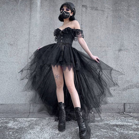 Front view of the black tutu skirt with the model holding the mesh layers outward, showing the gathered fullness and uneven hem.