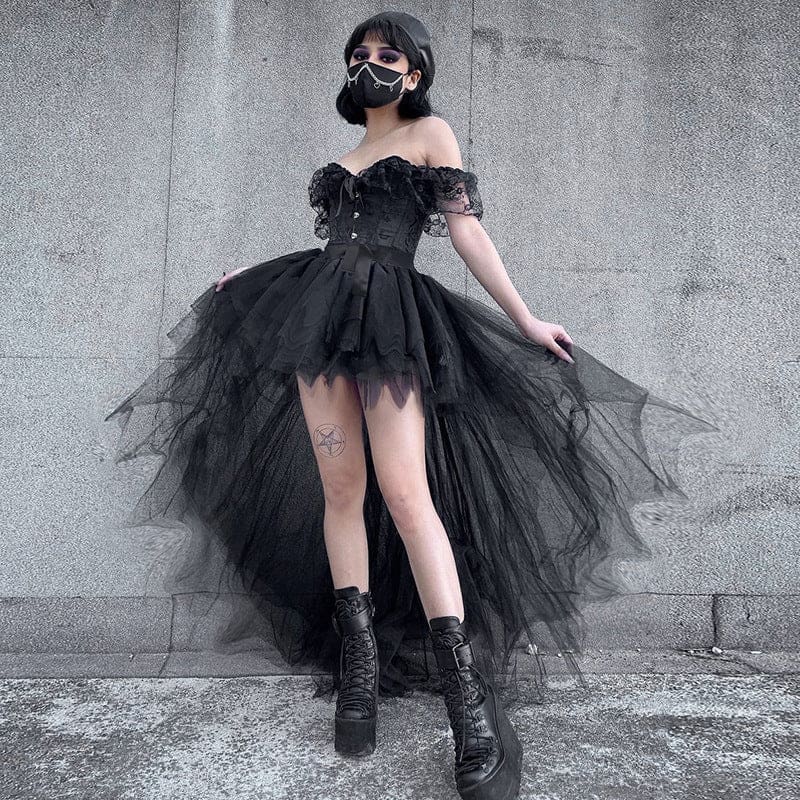 Front view of the black tutu skirt with the model holding the mesh layers outward, showing the gathered fullness and uneven hem.
