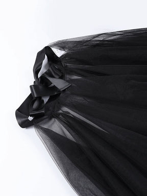 Close-up of the black skirt’s wide ribbon bow and gathered waistband above the first mesh layer.