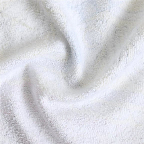 White reverse fabric of the floral skull rug shown in a broad fold, revealing the cloth texture.