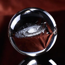 Clear galaxy sphere shown without a stand, with tiny white points forming a spiral inside.