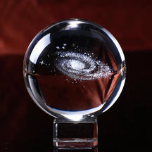 Clear crystal ball and square base with the galaxy spiral presented across the centre of the sphere.