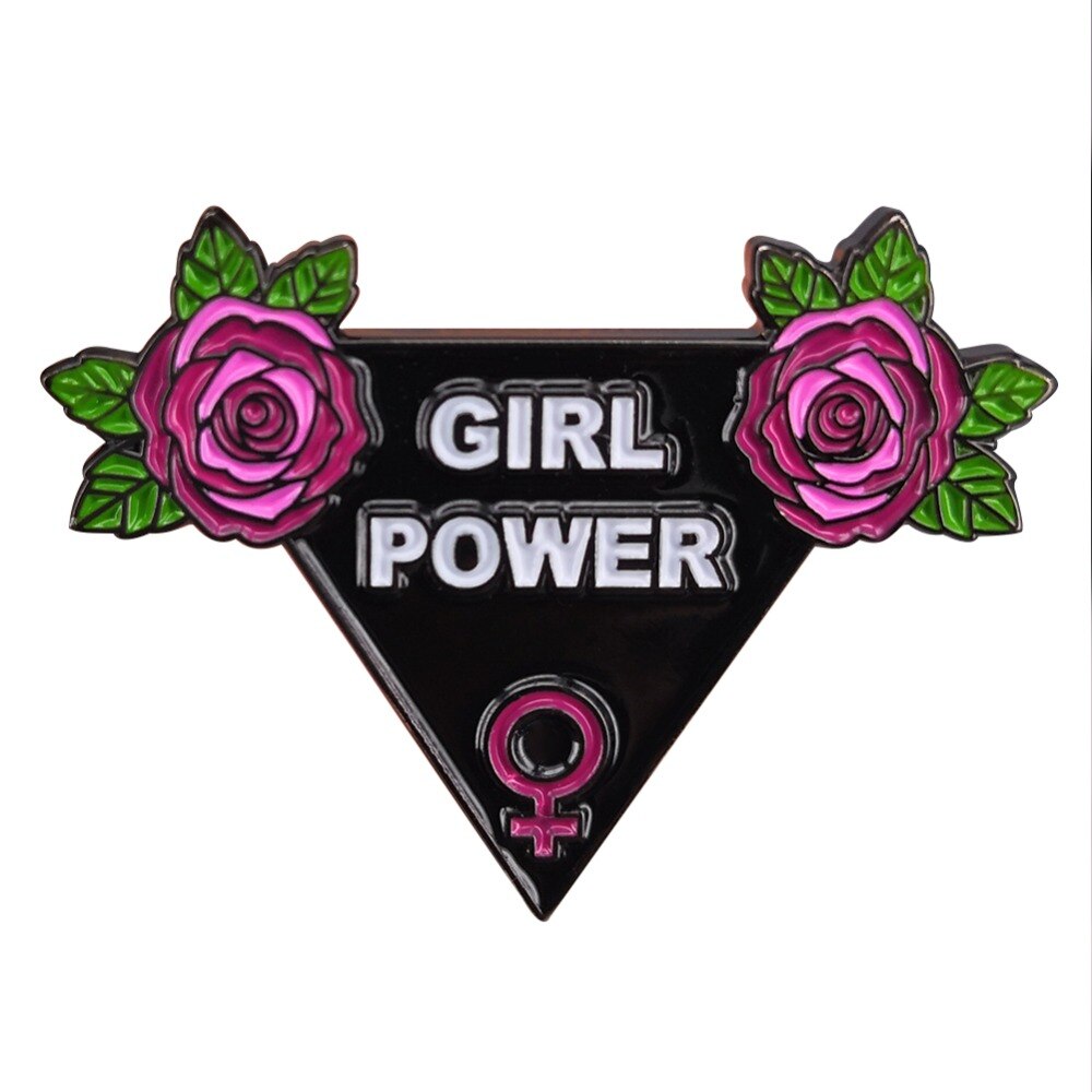 Black triangle Girl Power enamel pin with white lettering, pink roses, green leaves and a pink Venus symbol, shown against a white background.