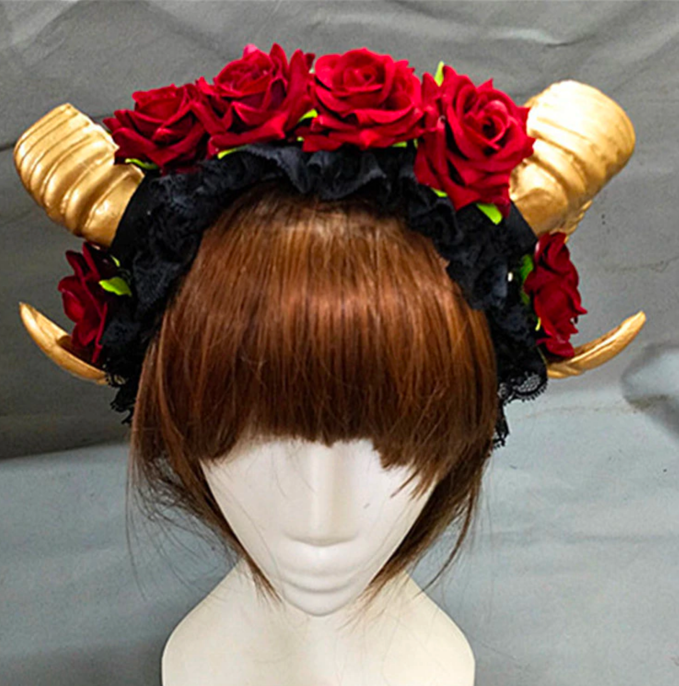 Demon horn headband with gold-tone curled horns and red roses.