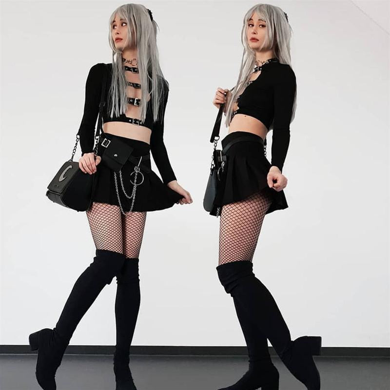 Two side-by-side outfit views of the black buckle crop top with a short skirt, fishnet tights and tall black footwear.