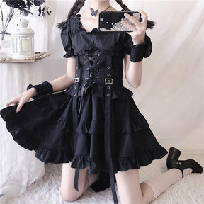 Another copy of the mirror view of the black ruffle dress, showing the long harness ribbons and puff sleeves.